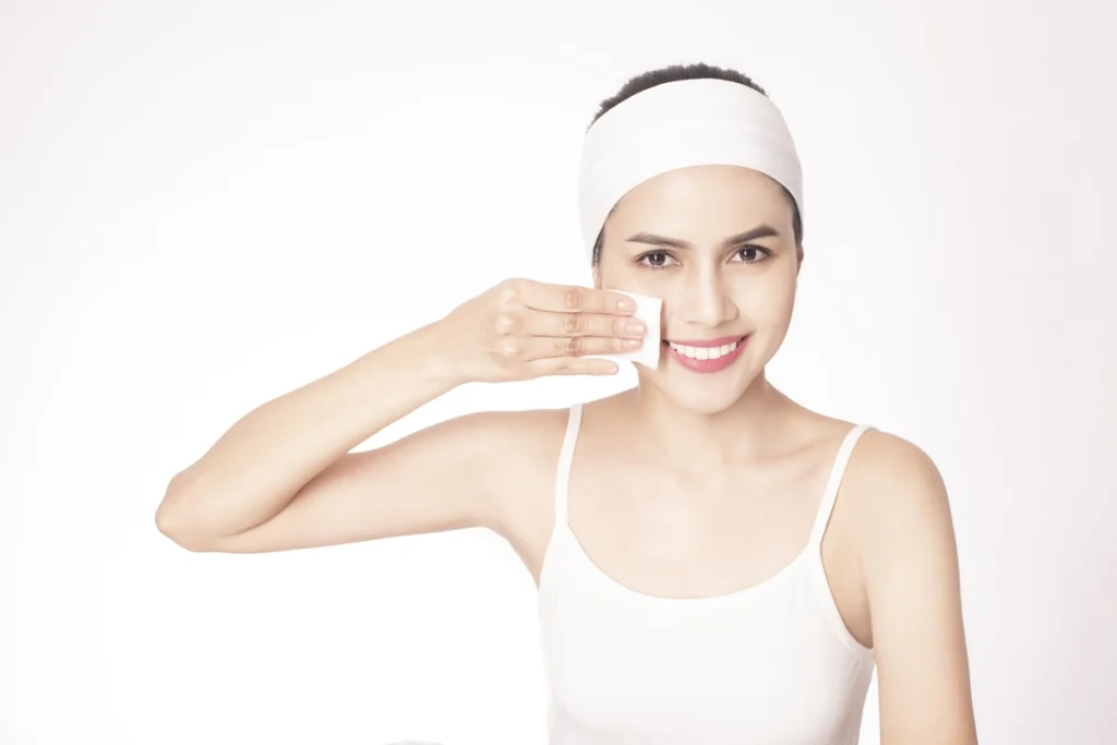 beautiful woman cleansing her face